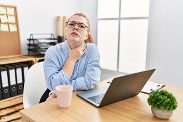 Poster - Young redhead woman working at the office using computer laptop touching painful neck, sore throat for flu, clod and infection