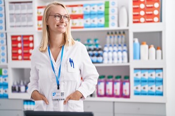 Sticker - Young blonde woman pharmacist smiling confident standing at pharmacy