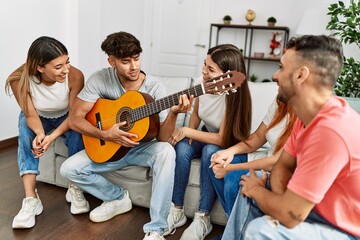 Sticker - Group of young friends having party playing guitar at home.