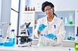 © Krakenimages.com - African american woman wearing scientist uniform working at laboratory