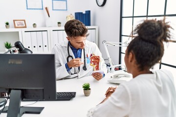 Wall Mural - Man and woman wearing doctor uniform having otolaryngology consultation at clinic