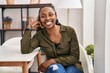 © Krakenimages.com - African american woman smiling confident sitting on chair at home