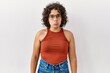 © Krakenimages.com - Young hispanic woman wearing glasses standing over isolated background depressed and worry for distress, crying angry and afraid. sad expression.