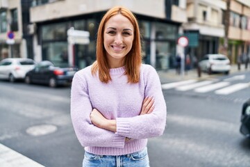 Sticker - Young caucasian woman standing with arms crossed gesture at street