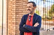 © Krakenimages.com - Middle age man smiling confident standing with arms crossed gesture at street