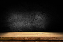 Wooden Table In Dark Room Background Concept For Advertising.