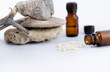 homeopathy granules with glass bottles and rocks on white background