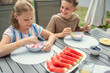 © spass - Teen brother and suster having breakfast outdoors
