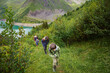 © Anna - Father and sons hiking together, long walk, summer activities for family in the mountains.