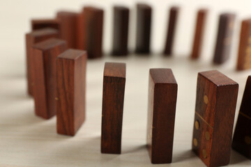 Sticker - Wooden domino tiles on white table, closeup