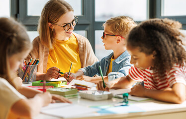 Teacher helping children with schoolwork