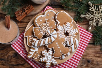 Wall Mural - Delicious gingerbread Christmas cookies on wooden table, flat lay