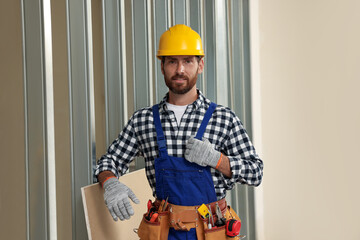 Sticker - Professional builder in uniform with tool belt indoors