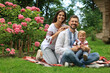 © New Africa - Happy family in Ukrainian national clothes on green grass outdoors
