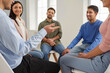 © Studio Romantic - Group of people having a discussion during a business meeting in the office. Team of happy smiling employees sitting in a circle and talking. Young men and women discussing something in group therapy