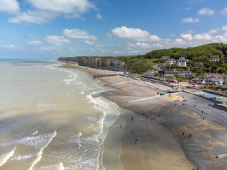 Aerial view on chalk cliffs, green meadows and water of Atlantic ocean near small village Veules-les-Roses, Normandy, France. Tourists destination.