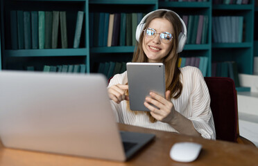 Remote work programmer woman programming uses a powerful laptop, a workplace in a new office