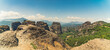 © PoppyPix - Panoramic drone shot of the tops of natural rock formations in Greece visited by a group of tourists. Summer holidays destination concept. Blue sky. High quality photo