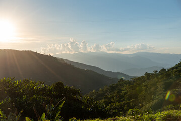 Wall Mural - Sunset over mountains with crops in a Colombian landscape.