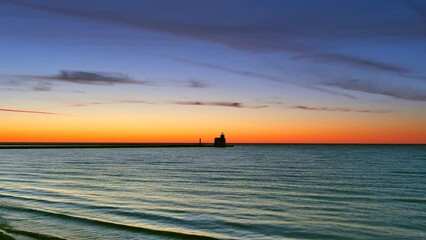 Wall Mural - Delicate waves ripple onto the beach at morning twilight, reflecting amazingly colorful dawn sky.
