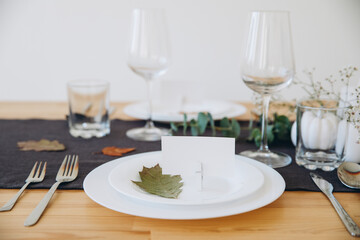 Wall Mural - Thanksgiving table setting, tableware and decorations. Blank white postcard on table mockup.