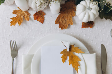 Wall Mural - Thanksgiving table setting, tableware and decorations. Blank white postcard on table mockup, top view