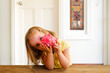 © Austockphoto - young girl wearing yellow blouse holding a pink piggy bank