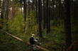 © Alexey - a young freelance girl is working on a laptop in the woods. remote work in nature