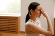 © Drobot Dean - Young white woman meditating on mat during yoga practice