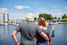 Senior Man With Arm Around Woman Looking At Harbor