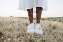Woman Wearing Shoes Standing In Meadow