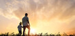 Father and his daughter walk outdoors at sunset times. outdoors and happy Family Concept.