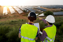 Male Engineers Discussing Solar Power Plant Construction