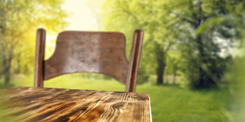 Wall Mural - Table background with chair and blurred garden background. 