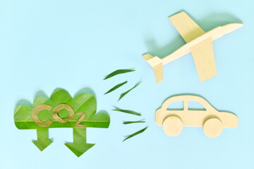 Air and land travel or transportation industry carbon emission reduction concept. Airplane and car vehicle releasing low CO2 icon green leaf cutout.