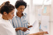 © (JLco) Julia Amaral - Young businesswomen analysing some documents in an office