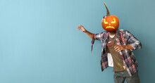 Scary Man With Carved Pumpkin Instead Of His Head On Blue Background With Space For Text. Halloween Celebration