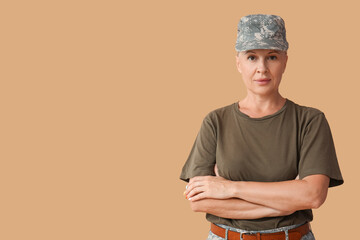 Wall Mural - Mature female soldier on beige background