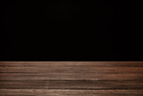 Fototapeta Sawanna - Wooden table top on black background