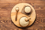 Fototapeta Kawa jest smaczna - Board with bowls of sesame seeds on wooden background