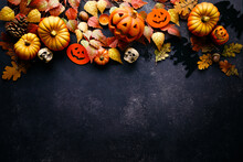Pumpkins With Halloween Decorations On Dark Background