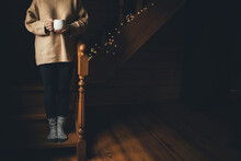 Young Woman Wearing Warm Sweater Drinking Hot Tea In A Cozy Wooden Country House.