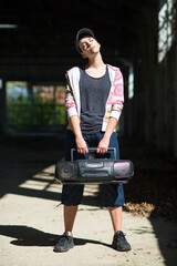 Wall Mural - Young female hip hop dancer standing in abandoned building on a sunny summer day