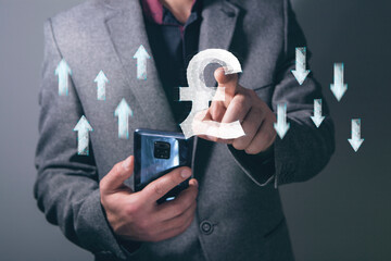 Wall Mural - Rise and fall of the pound from the network. Man tapping on the screen