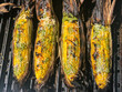 GRILLED CORN COVERED IN SPICY AIOLI AND PARMESAN