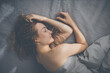 © lightpoet - Pretty, young woman sleeping in her bed late in the morning on a weekend - compensating for the lack of sleep