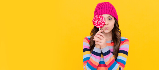 Poster - surprised teen girl hold lollipop. lollipop lady. hipster kid with colorful lollypop sugar candy. Teenager child with sweets, poster banner header, copy space.