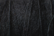 Extremely Close-up Macro Of The Surface Of A Spool Of Thread In Black. Low Key. Selective Focus. Macro Shot