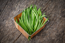 Organically Homegrown French Filet Green Beans, 'Maxibel' Variety, In A Quart Container On A Rustic Vintage Wooden Background