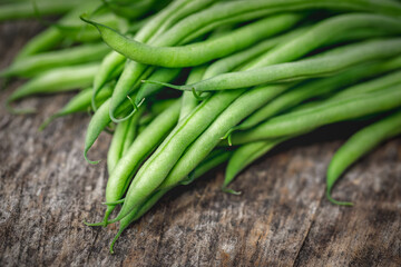 Wall Mural - Bunch of organically grown 'Maxibel' French filet green beans harvested from a home garden on a rustic wooden table